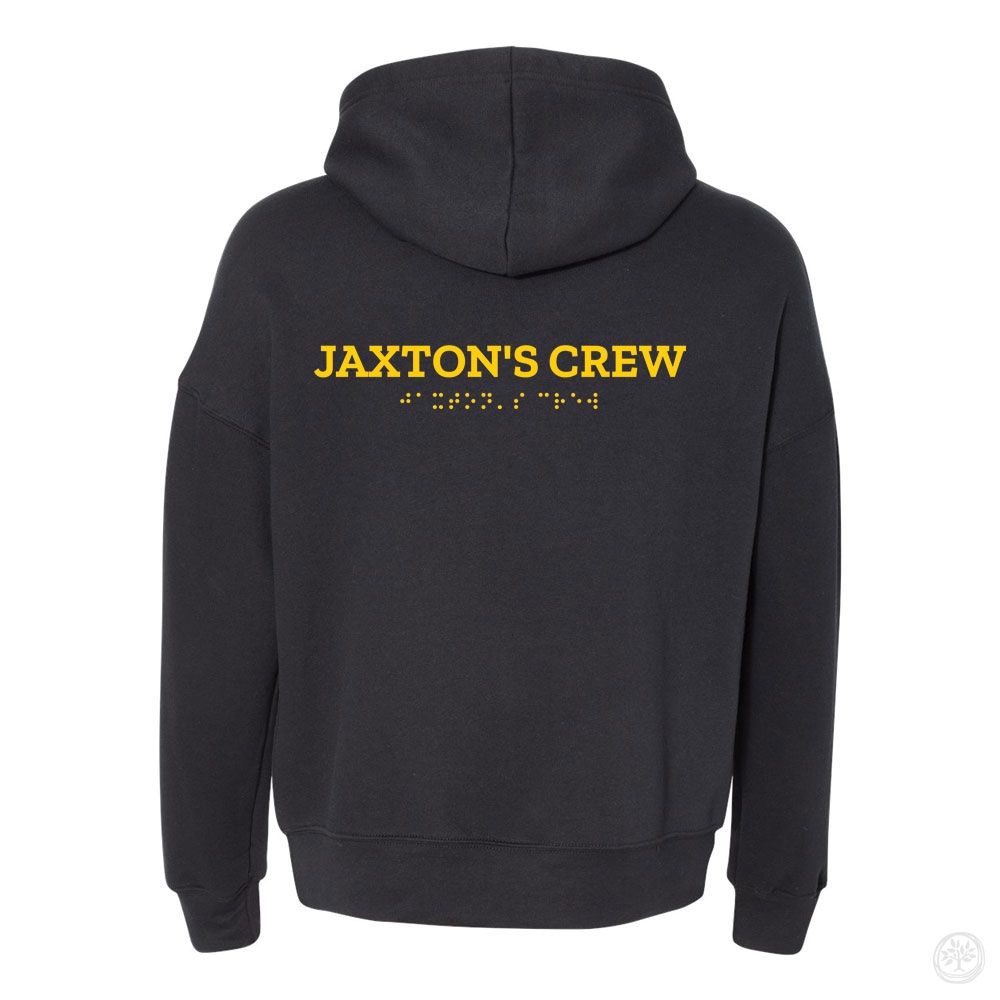 Back view of a black hoodie with bold yellow text reading ‘Jaxton’s Crew,’ with matching Braille text printed below.