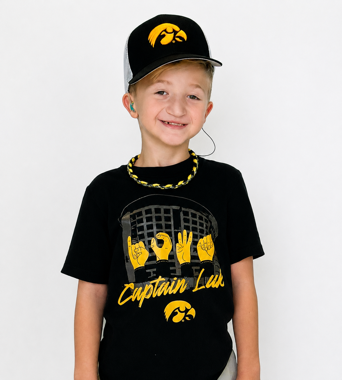 University of Iowa Kid Captain Luke wearing a custom Hawkeye t-shirt and hat created by licensed Iowa apparel vendor CAUSETEAM.